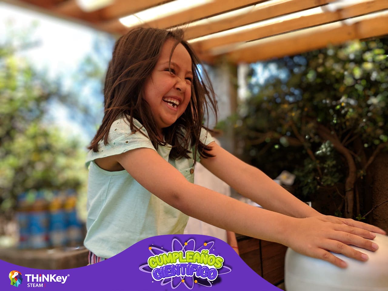 A child with a joyful expression, engaging in playful activity outside.